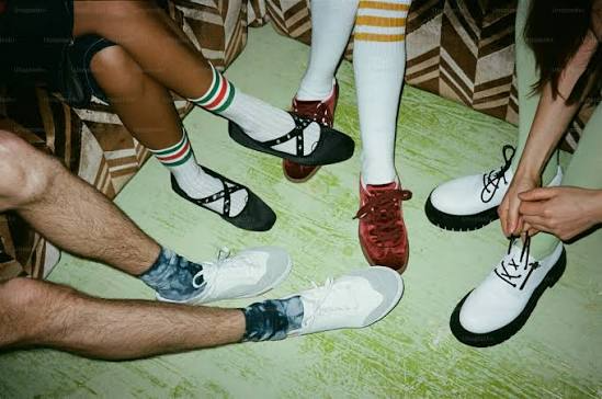 People wearing sneakers on a city street at night